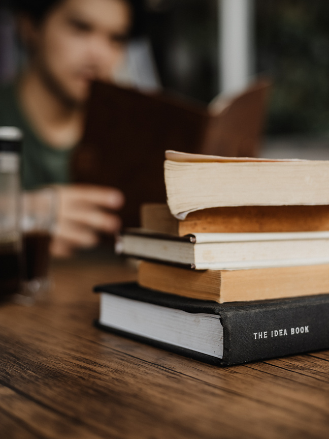 Stack of Books on Wooden Table